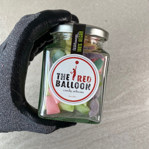 230g jar of Sour Suckers candy pebbles.