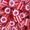 Red and white striped candy with inner Double Happiness centered symbol. Mandarin flavour.