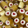 Gold wrapped rock candy with a red centered love heart. Watermelon flavour.