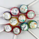 Baby Pops are boy or girl themed baby shower lollipops with designs incl. elephants, stripped onesies, boy & girl mice, happy moons, a stalk carrying a new bundle of joy, baby foot prints, building blocks and cursive textile prints with "love", "oh baby" & "Ready to Pop!".